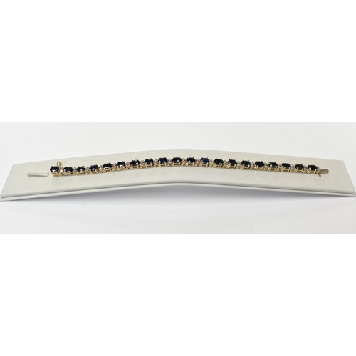 62 - A STUNNING 14CT YELLOW GOLD SAPPHIRE & DIAMOND TENNIS BRACELET, made up of 20 oval faceted sapphire ... 