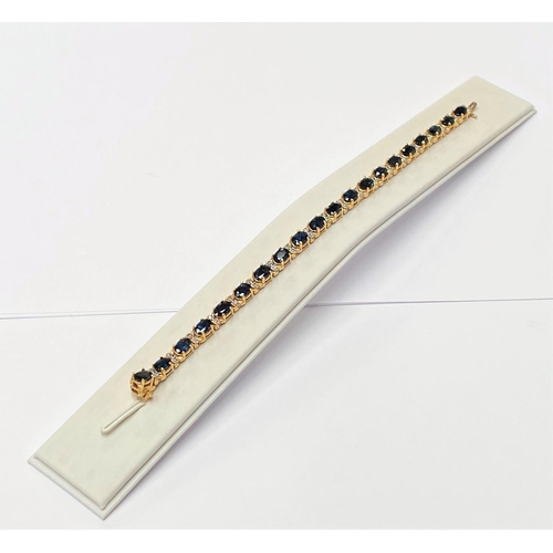 62 - A STUNNING 14CT YELLOW GOLD SAPPHIRE & DIAMOND TENNIS BRACELET, made up of 20 oval faceted sapphire ... 