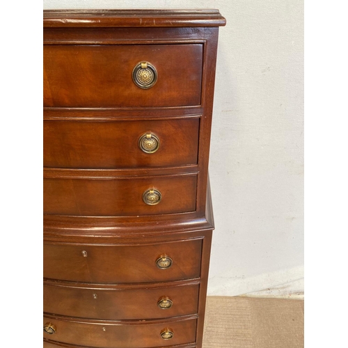 64 - A MAHOGANY BOW FRONTED CHEST ON CHEST, comprising of seven drawers in a 3 over 4 arrangement; with b... 