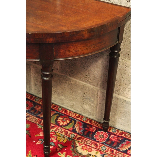 66 - A FINE GEORGIAN DEMI LUNE FOLD OVER MAHOGANY CARD TABLE,	with subtle cross-banding to be found on th... 