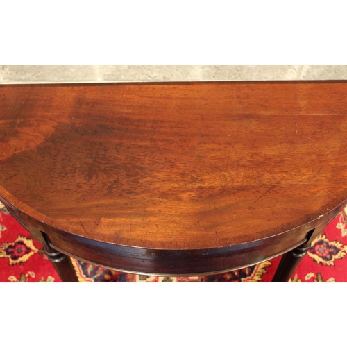 66 - A FINE GEORGIAN DEMI LUNE FOLD OVER MAHOGANY CARD TABLE,	with subtle cross-banding to be found on th... 