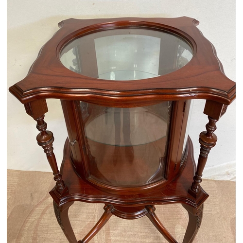 68 - AN UNUSUAL CIRCULAR MAHOGANY DISPLAY CABINET, bow fronted glass to front, with two turned supports, ... 