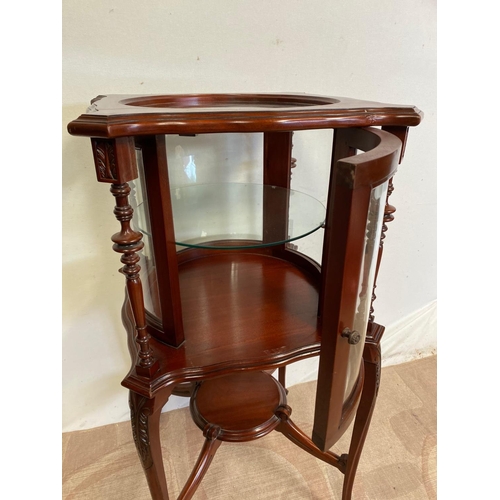 68 - AN UNUSUAL CIRCULAR MAHOGANY DISPLAY CABINET, bow fronted glass to front, with two turned supports, ... 