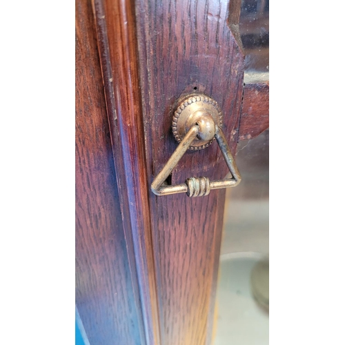 72 - A VERY FINE ANTIQUE OAK BOW FRONTED GLAZED CORNER CABINET, carved dentil edge to the top and reeded ... 