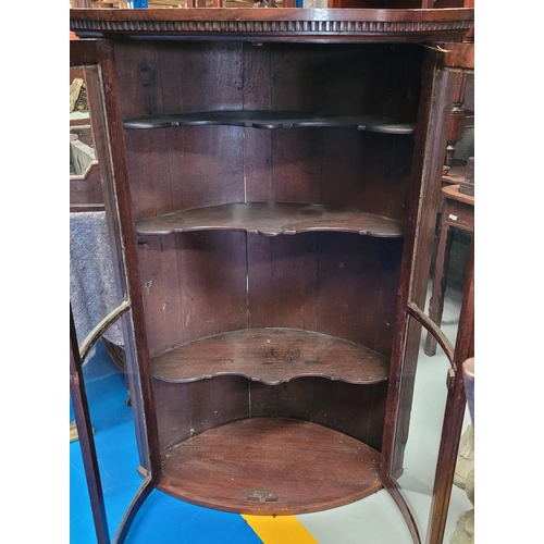 72 - A VERY FINE ANTIQUE OAK BOW FRONTED GLAZED CORNER CABINET, carved dentil edge to the top and reeded ... 