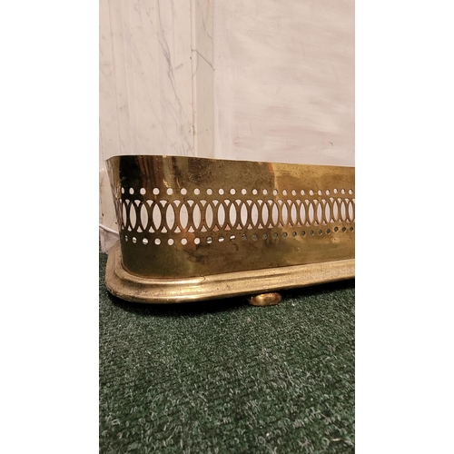 74 - A 19TH CENTURY PIERCED BRASS FIRE FENDER, with curved corners to the front, and a moulded graduated ... 