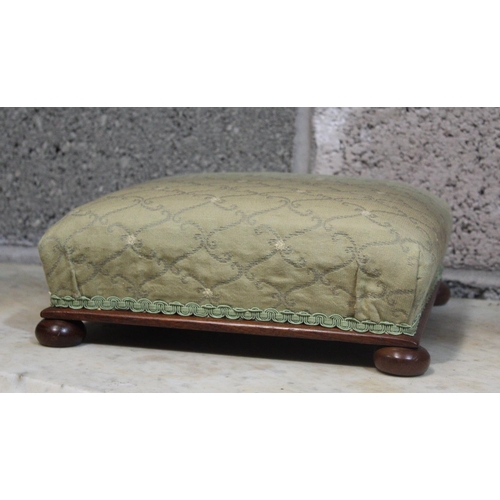 79 - A PAIR OF LOW RISE FOOT RESTS, 	each with stuffed over cushion, nicely upholstered, resting on bun f... 