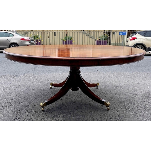 80 - A FINE CIRCULAR MAHOGANY DINING TABLE, striking mahogany top sits upon a short carved and turned col... 