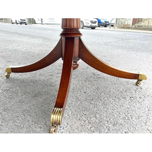 80 - A FINE CIRCULAR MAHOGANY DINING TABLE, striking mahogany top sits upon a short carved and turned col... 