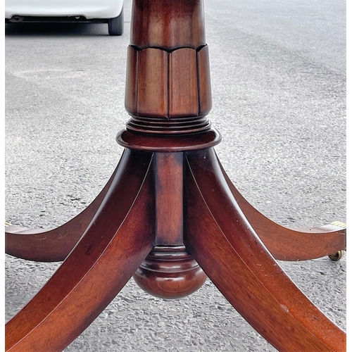 80 - A FINE CIRCULAR MAHOGANY DINING TABLE, striking mahogany top sits upon a short carved and turned col... 