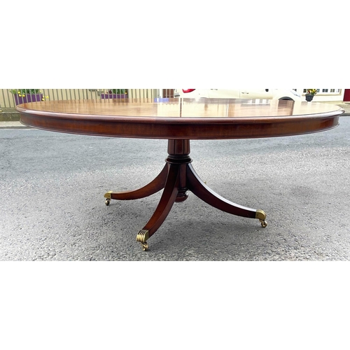 80 - A FINE CIRCULAR MAHOGANY DINING TABLE, striking mahogany top sits upon a short carved and turned col... 