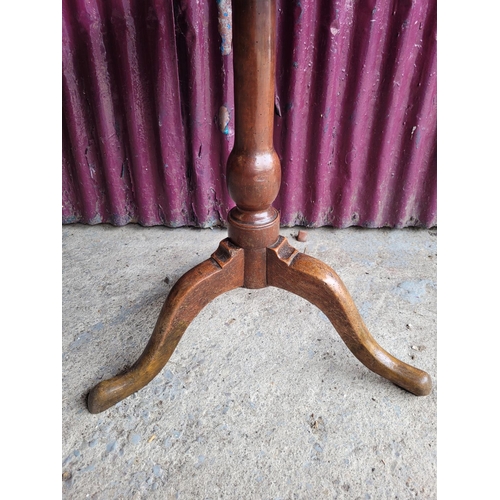 91 - AN 18TH CENTURY TIP UP CENTRE TABLE, with oak top and fruit wood base, a column support on a tripod ... 