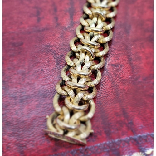 119 - A VINTAGE 18CT YELLOW GOLD LINK BRACELET, circa 1950. A charming vintage piece; designed with a seri... 