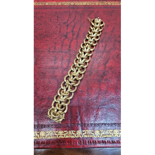 119 - A VINTAGE 18CT YELLOW GOLD LINK BRACELET, circa 1950. A charming vintage piece; designed with a seri... 