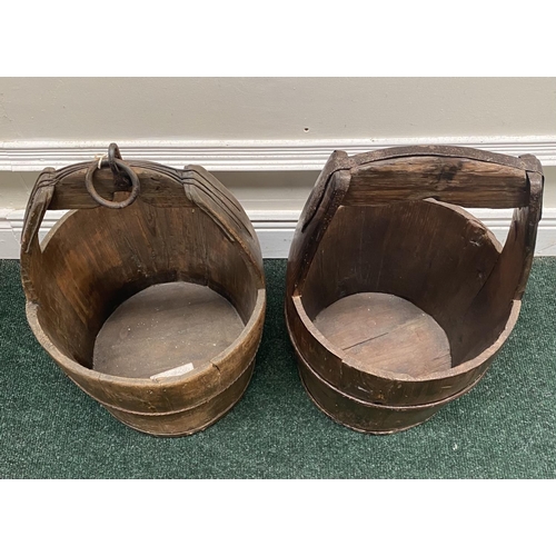 111 - TWO ANTIQUE ROUND COOPERED WOODEN WATER BUCKETS, one with iron binding, both with carrying handles, ... 