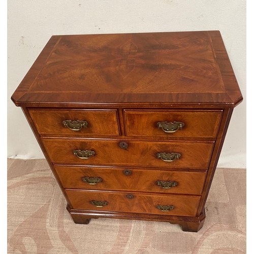 12 - A WALNUT CHEST/DRINKS CABINET, with crossbanding, lift-top revealing interior storage, three drawers... 