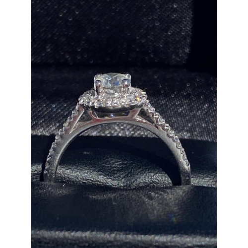 126 - A CLASSIC 18CT WHITE GOLD DIAMOND HALO RING, centre diamond weight: .65ct. Total diamond weight: 1.0... 