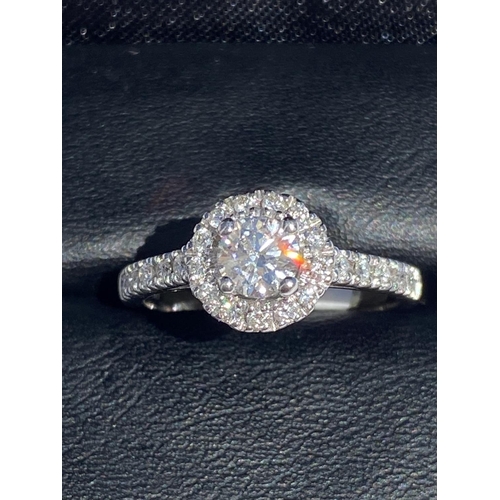 126 - A CLASSIC 18CT WHITE GOLD DIAMOND HALO RING, centre diamond weight: .65ct. Total diamond weight: 1.0... 