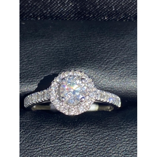 126 - A CLASSIC 18CT WHITE GOLD DIAMOND HALO RING, centre diamond weight: .65ct. Total diamond weight: 1.0... 