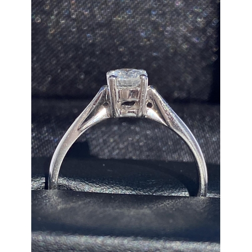 127 - A DELICATE 18CT WHITE GOLD SOLITAIRE DIAMOND RING, diamond weight: .59cts. Set in a four claw settin... 