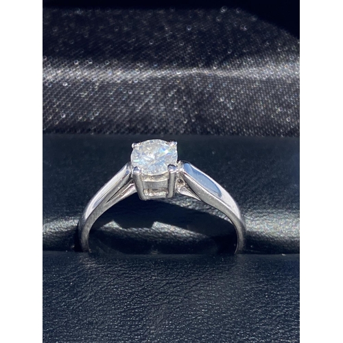 127 - A DELICATE 18CT WHITE GOLD SOLITAIRE DIAMOND RING, diamond weight: .59cts. Set in a four claw settin... 