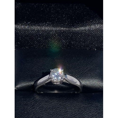 127 - A DELICATE 18CT WHITE GOLD SOLITAIRE DIAMOND RING, diamond weight: .59cts. Set in a four claw settin... 