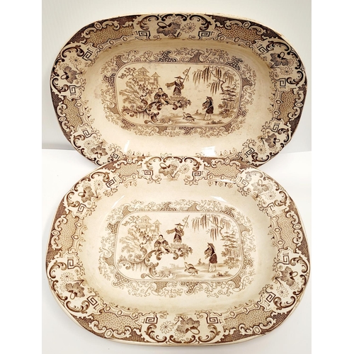 133 - A PAIR OF LARGE STONEWARE PLATTERS; each with brown & white decoration; showing figures and birds in... 