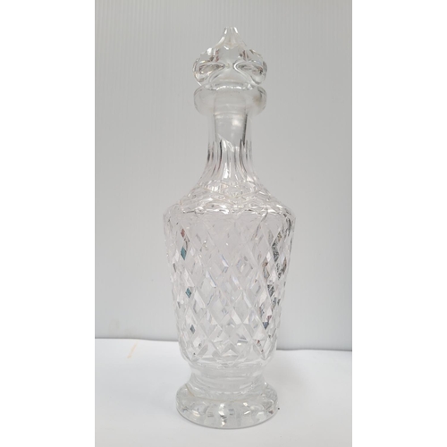 188 - AN EARLY 20TH CENTURY WATERFORD CUT GLASS DECANTER with stopper, the tapered body decorated with cro... 