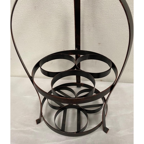 235 - A STEEL WINE RACK, holds three bottles, with decorative top and circular base. Dimensions: 54cm high... 