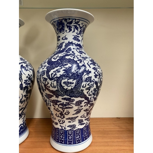 26 - A PAIR OF CHINESE BLUE AND WHITE PORCELAIN DRAGON VASES, each with Quianlong seal mark beneath. With... 