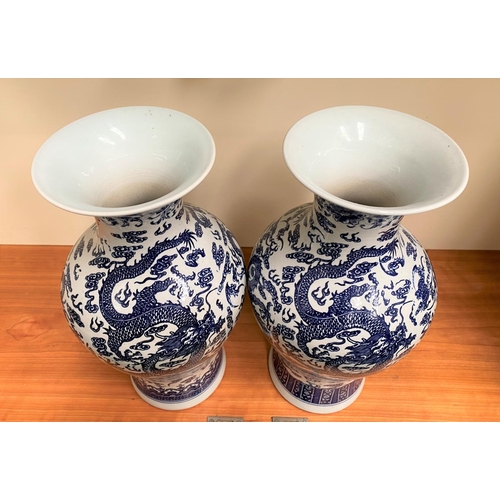 26 - A PAIR OF CHINESE BLUE AND WHITE PORCELAIN DRAGON VASES, each with Quianlong seal mark beneath. With... 