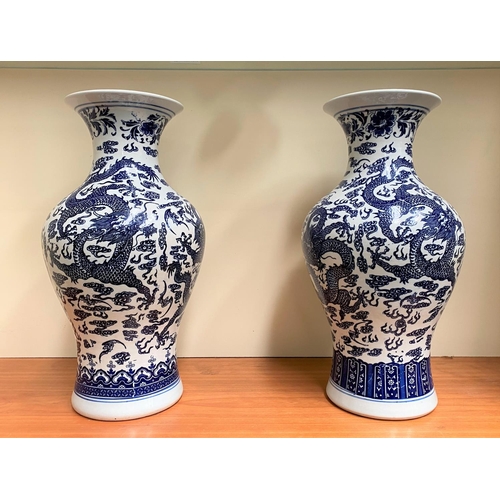 26 - A PAIR OF CHINESE BLUE AND WHITE PORCELAIN DRAGON VASES, each with Quianlong seal mark beneath. With... 