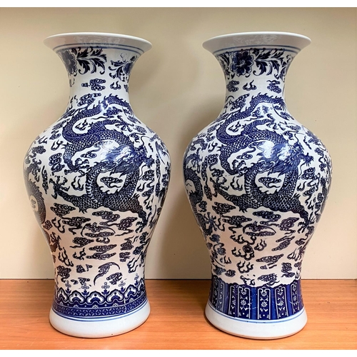 26 - A PAIR OF CHINESE BLUE AND WHITE PORCELAIN DRAGON VASES, each with Quianlong seal mark beneath. With... 