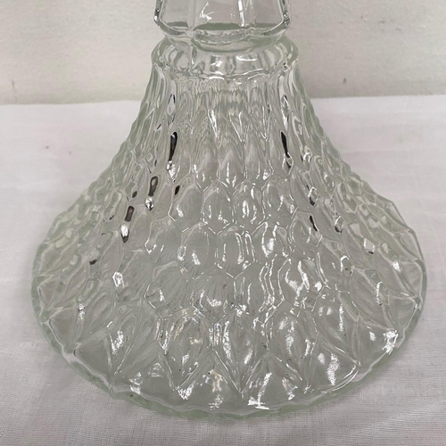 28 - A CUT GLASS SHIPS DECANTER AND STOPPER, with silver plated mount, fluted neck, body cut with hobnail... 