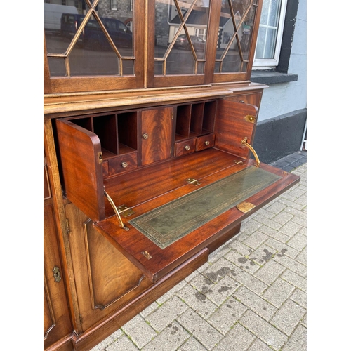 29 - A MAHOGANY BREAK FRONT SECRETAIRE LIBRARY BOOKCASE, with dentil cornice, architectural glazed doors ... 