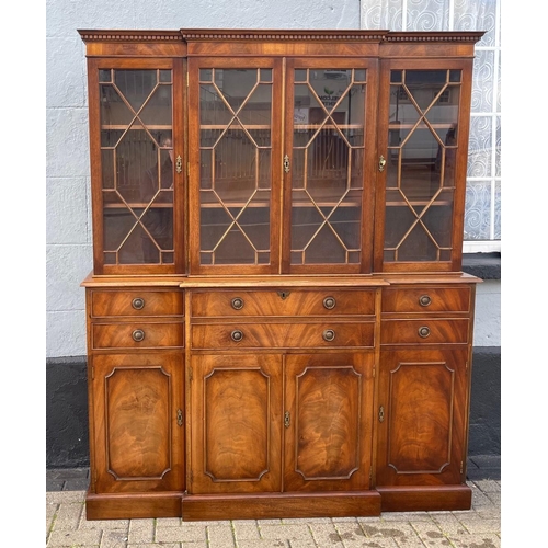 29 - A MAHOGANY BREAK FRONT SECRETAIRE LIBRARY BOOKCASE, with dentil cornice, architectural glazed doors ... 