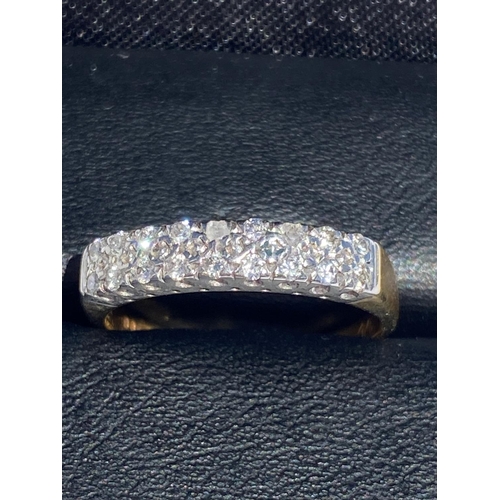 34 - A STRIKING 9CT YELLOW AND WHITE GOLD HALF ETERNITY DIAMOND RING, a very pretty design. Diamond weigh... 