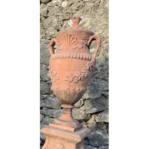 38 - A PAIR OF TERACOTTA STONE GARDEN URNS, classical shape and two-handled design, decorated with shell ... 