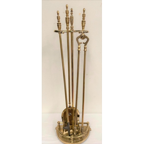 44 - A BRASS STAND WITH FIRE IMPLEMENTS, stand with shaped galleried base, includes shovel, poker and ton... 