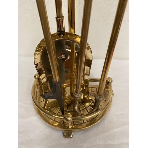 44 - A BRASS STAND WITH FIRE IMPLEMENTS, stand with shaped galleried base, includes shovel, poker and ton... 