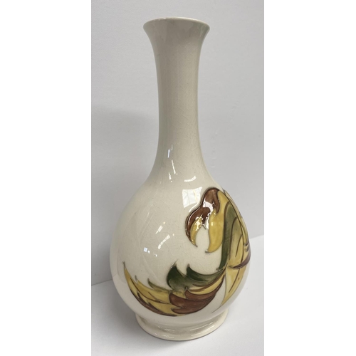 49 - A MOORCROFT POTTERY BUD VASE, in the tumbling leaves pattern, baluster form, with impressed and pain... 