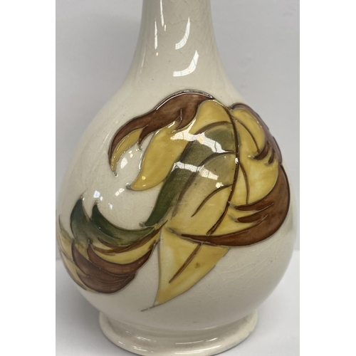 49 - A MOORCROFT POTTERY BUD VASE, in the tumbling leaves pattern, baluster form, with impressed and pain... 