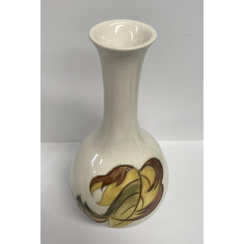 49 - A MOORCROFT POTTERY BUD VASE, in the tumbling leaves pattern, baluster form, with impressed and pain... 