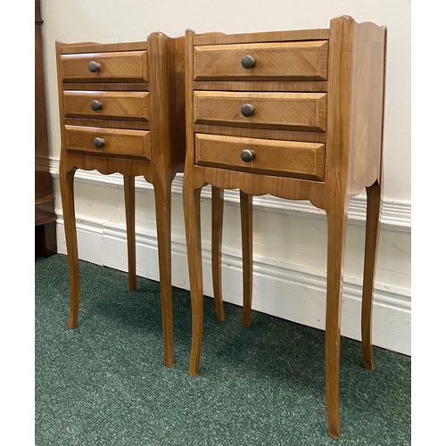 51 - A PAIR OF FRENCH STYLE FIGURED BEDSIDE CABINETS, with three drawers, crossbanding and shaped gallery... 