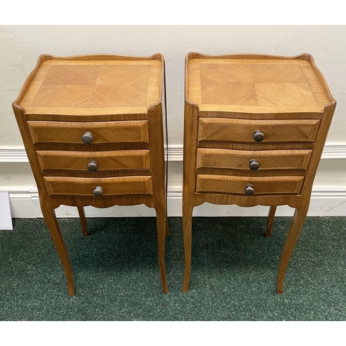 51 - A PAIR OF FRENCH STYLE FIGURED BEDSIDE CABINETS, with three drawers, crossbanding and shaped gallery... 