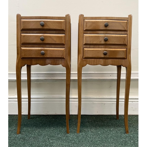 51 - A PAIR OF FRENCH STYLE FIGURED BEDSIDE CABINETS, with three drawers, crossbanding and shaped gallery... 