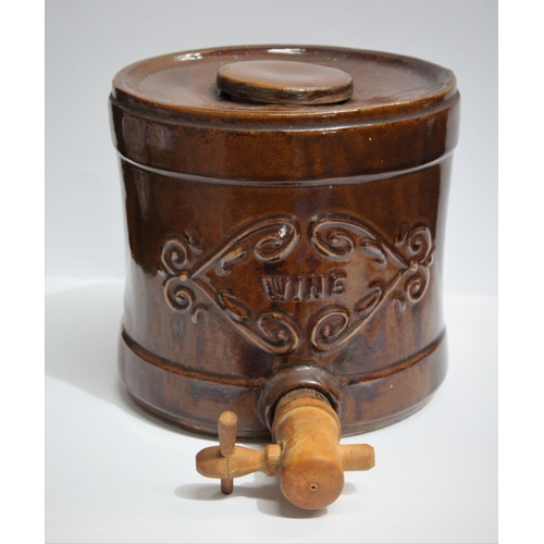 55 - A PAIR OF CERAMIC WINE DISPENSERS, each with a wooden tap and cork seal, and lift top lids; floral e... 