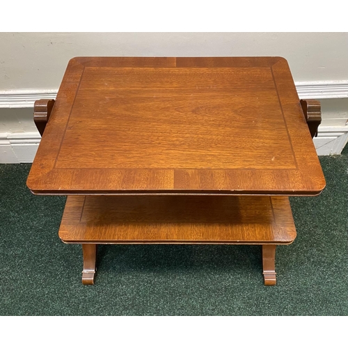 60 - A MAHOGANY CROSSBANDED TWO TIER SIDE TABLE, fluted side supports with brass lion handles, turned cro... 