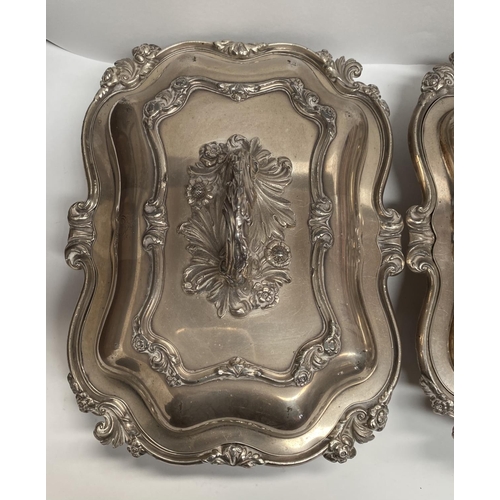 92 - A PAIR OF EARLY 20TH CENTURY SILVER PLATED ENTRÉE DISHES, finely decorated with scroll shaped edge a... 