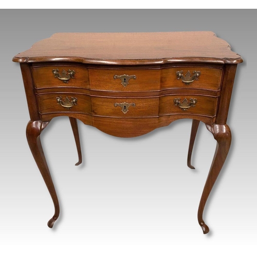 10 - A QUEEN ANNE STYLE WALNUT DESK, serpentine front with two drawers having brass handles, supported by... 